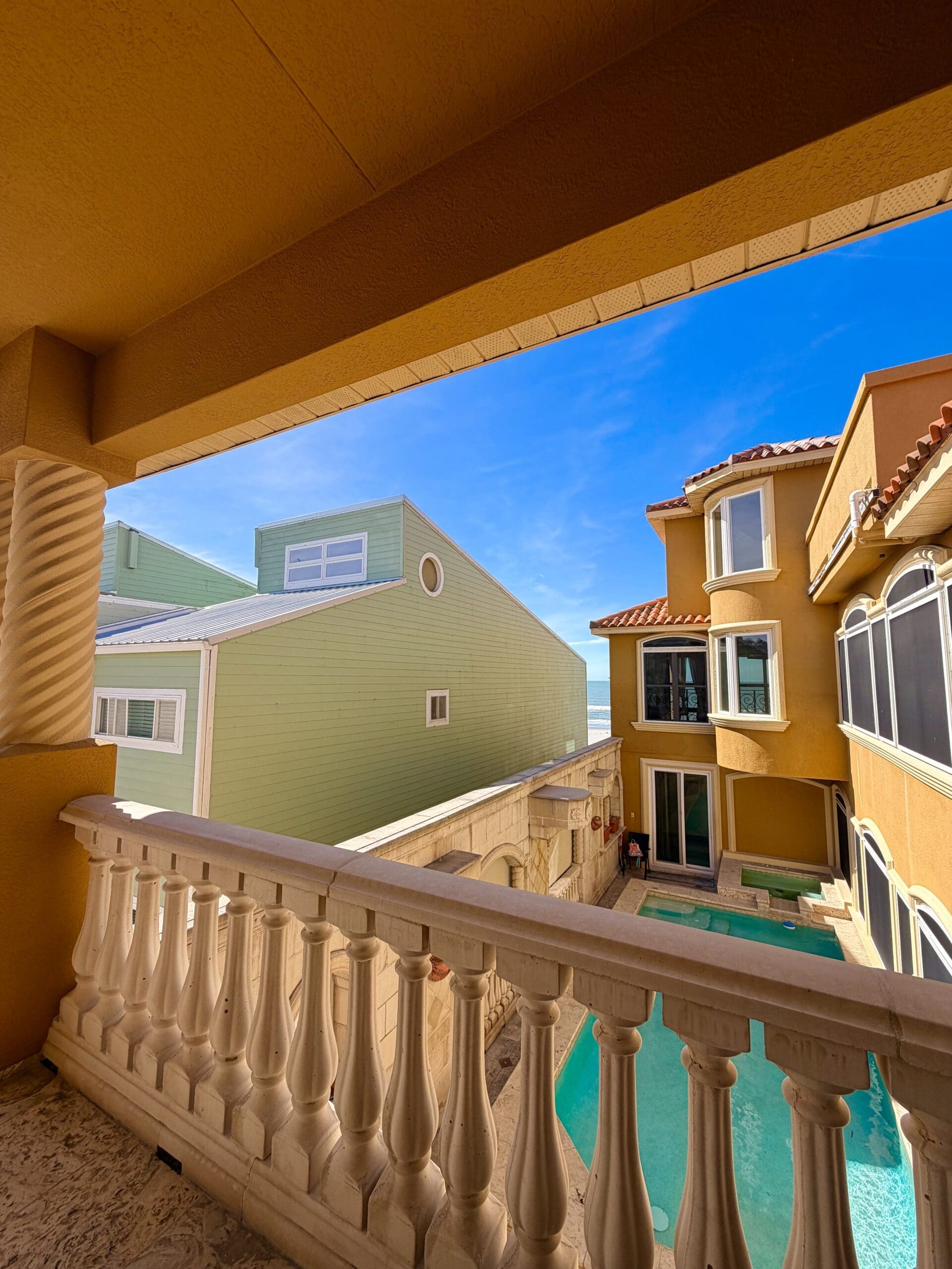 Balcony view of a luxury beachfront vacation home with private pool in Indian Rocks Beach, Florida.