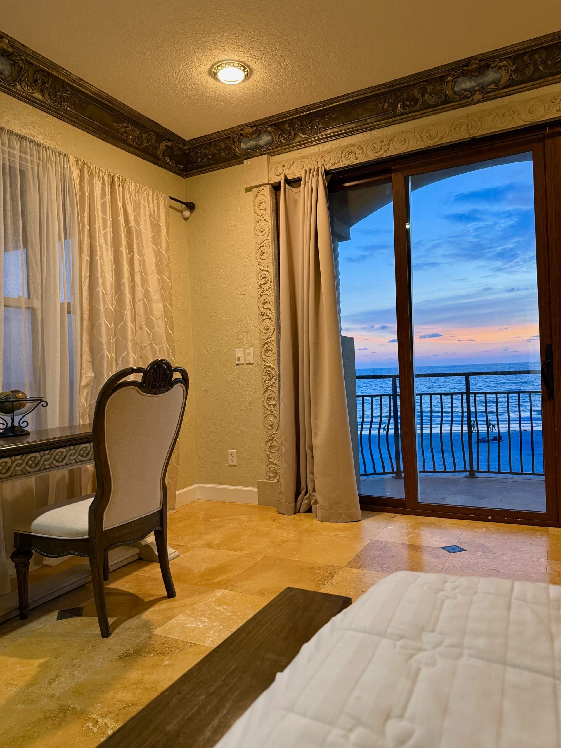 Luxury beachfront bedroom with sunset ocean views at an Indian Rocks Beach vacation rental.