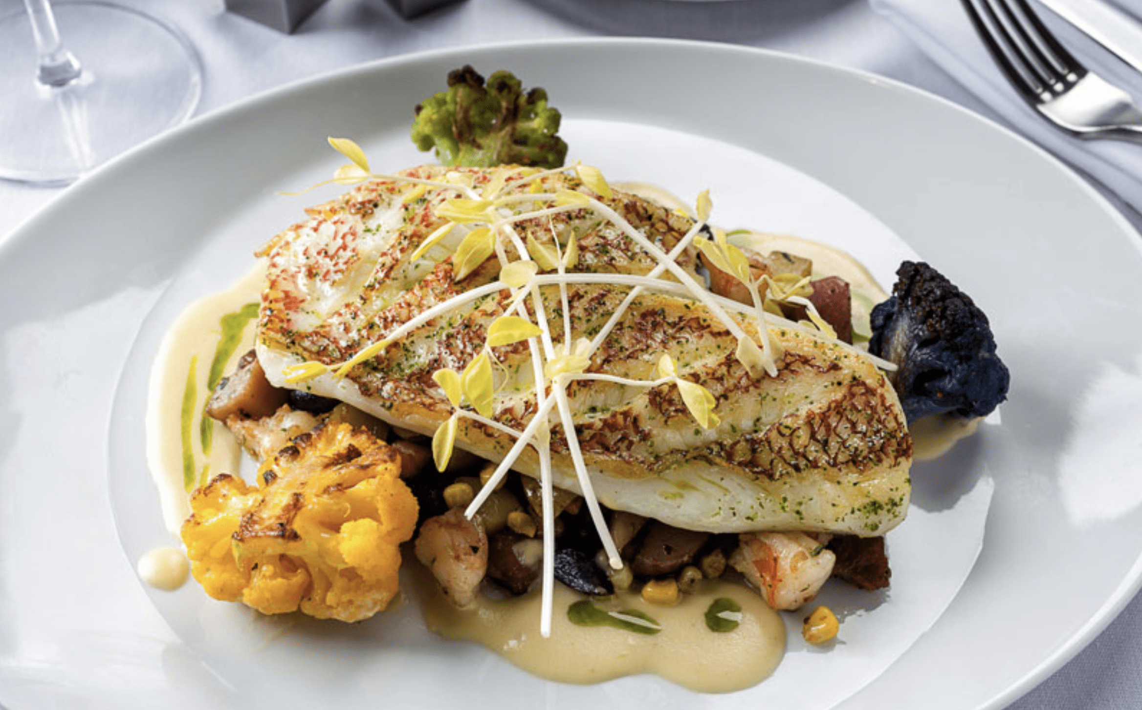 Gourmet fish fillet served with roasted vegetables at a Clearwater Beach restaurant