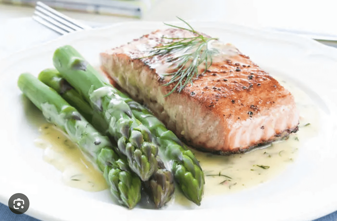 Fresh grilled salmon with asparagus served at a Clearwater Beach vacation rental kitchen.