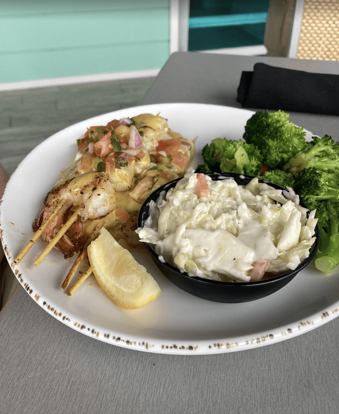 Grilled shrimp skewers with pico de gallo and coleslaw at a Clearwater Beach restaurant