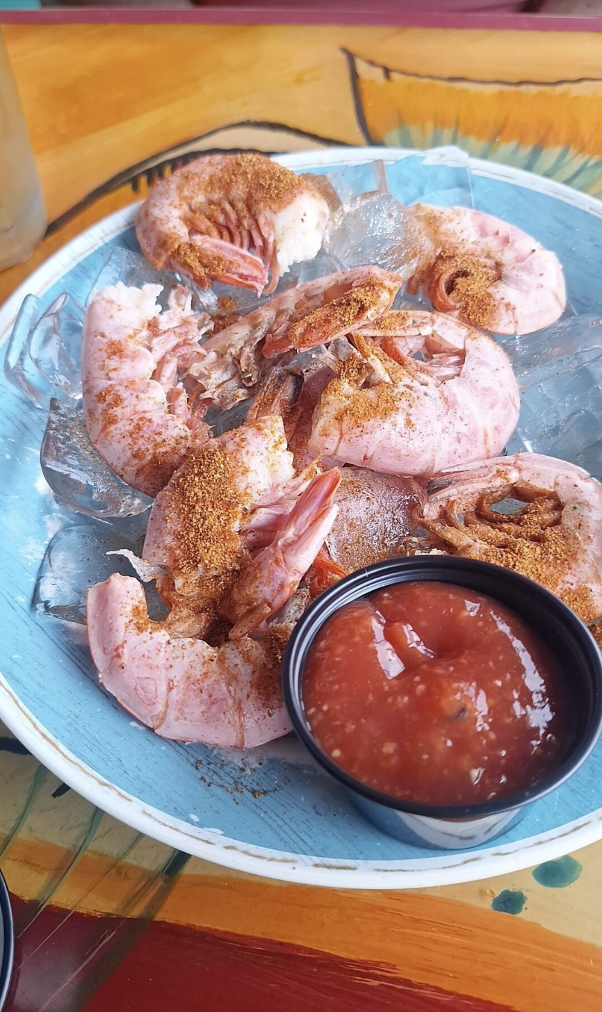 Boiled shrimp seasoned with spices and served with cocktail sauce.