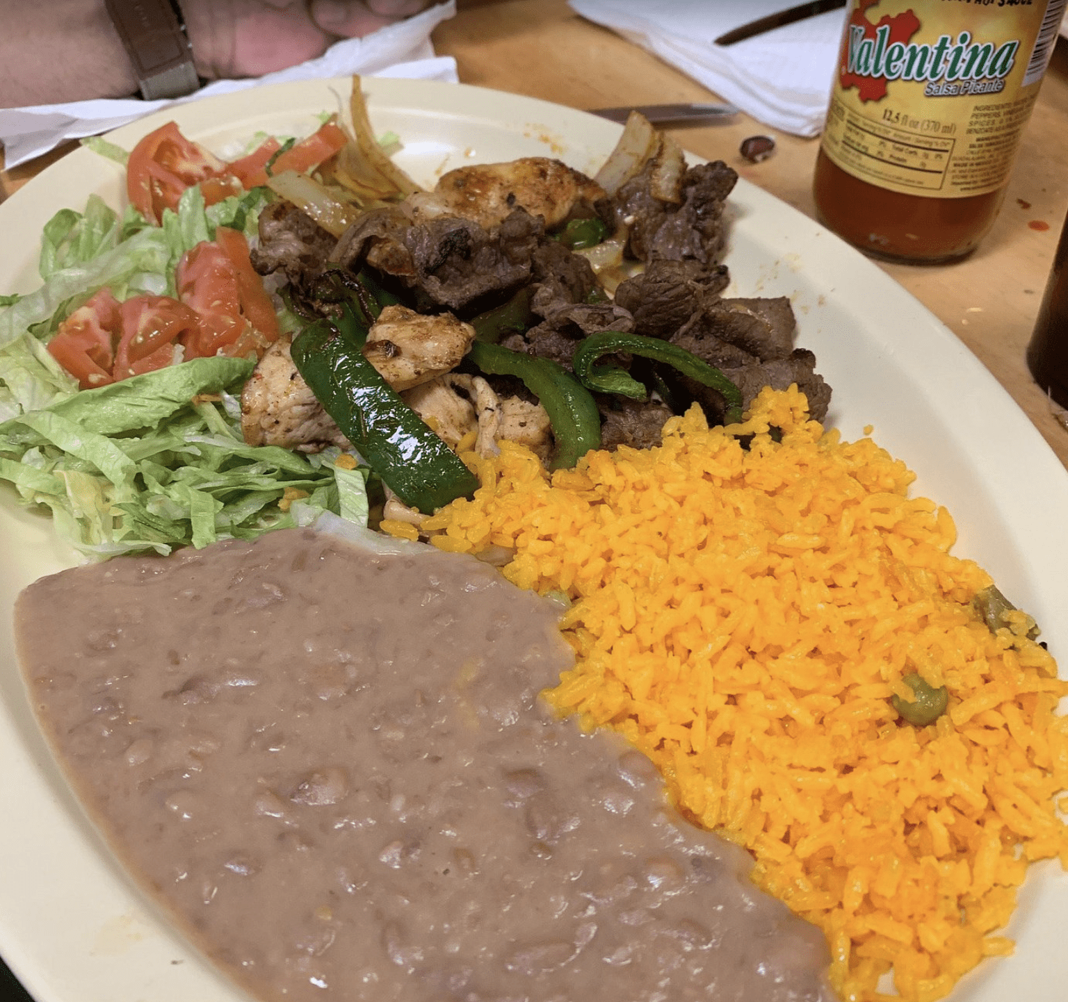 Mexican fajitas with rice, beans, grilled meat, peppers, and lettuce served in Clearwater Beach.