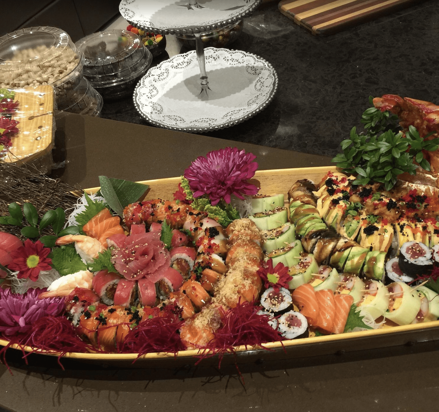 Assorted sushi and sashimi beautifully arranged on a wooden sushi boat in Clearwater Beach.