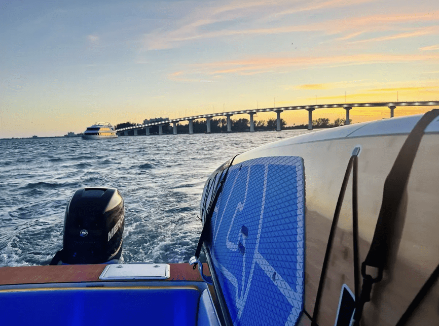 Boat cruising under the bridge at sunset near Clearwater Beach, Florida.