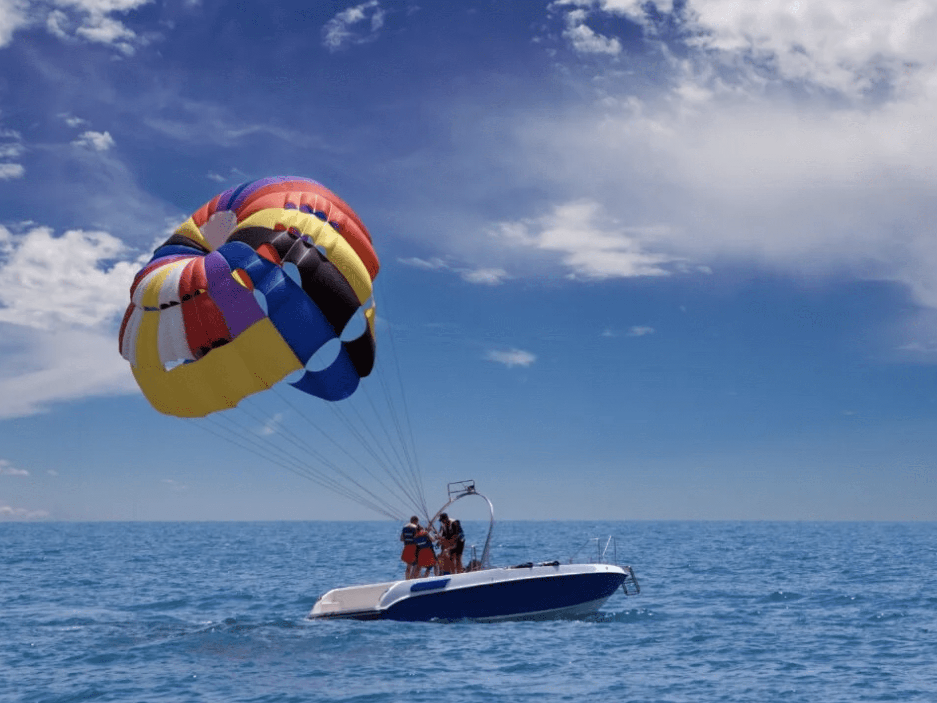 Parasailing over the ocean with colorful parachute near Clearwater Beach, Florida.