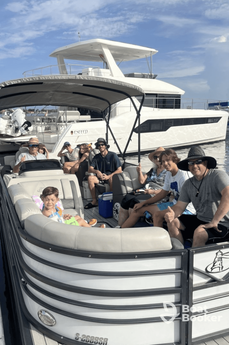 Family enjoying a sunny day on a pontoon boat rental in Clearwater Beach, Florida.