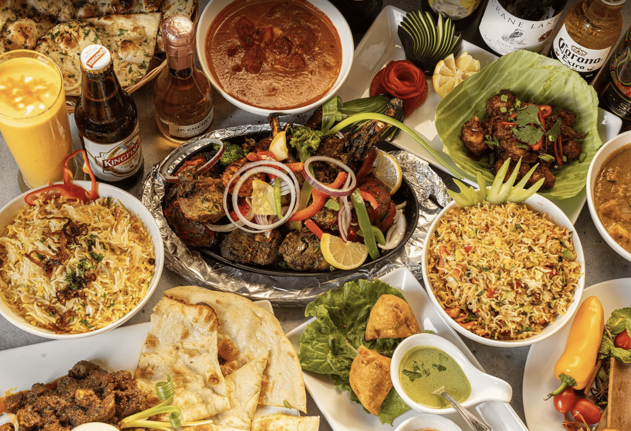 Colorful Indian cuisine with curry, biryani, naan, and appetizers at a Clearwater Beach restaurant.