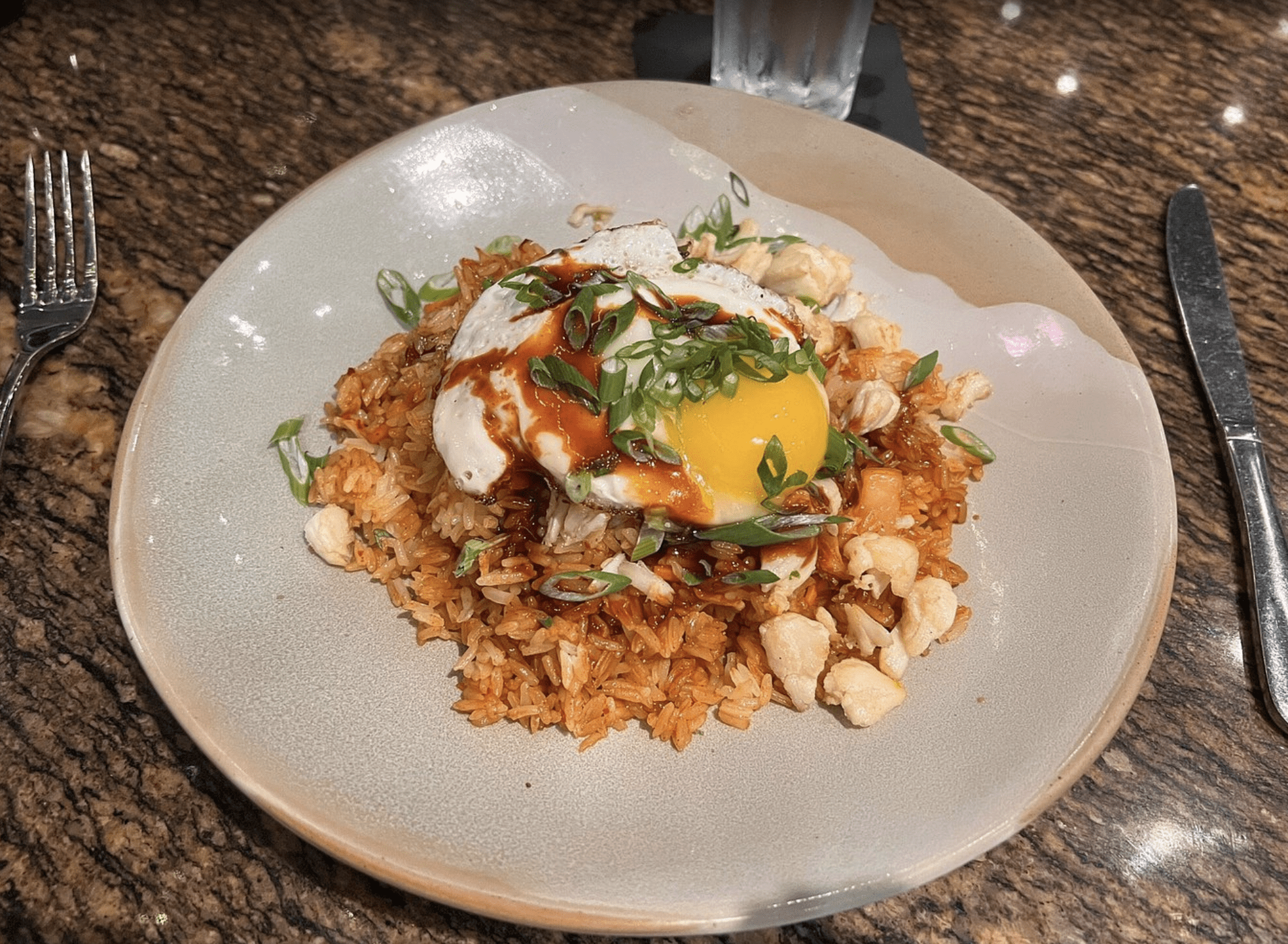 Kimchi fried rice topped with a sunny-side-up egg and scallions at a Clearwater Beach restaurant.