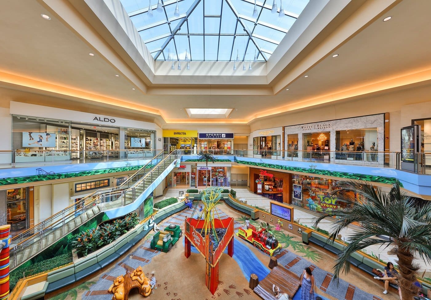 Countryside Mall Clearwater interior with skylight, stores, and play area.